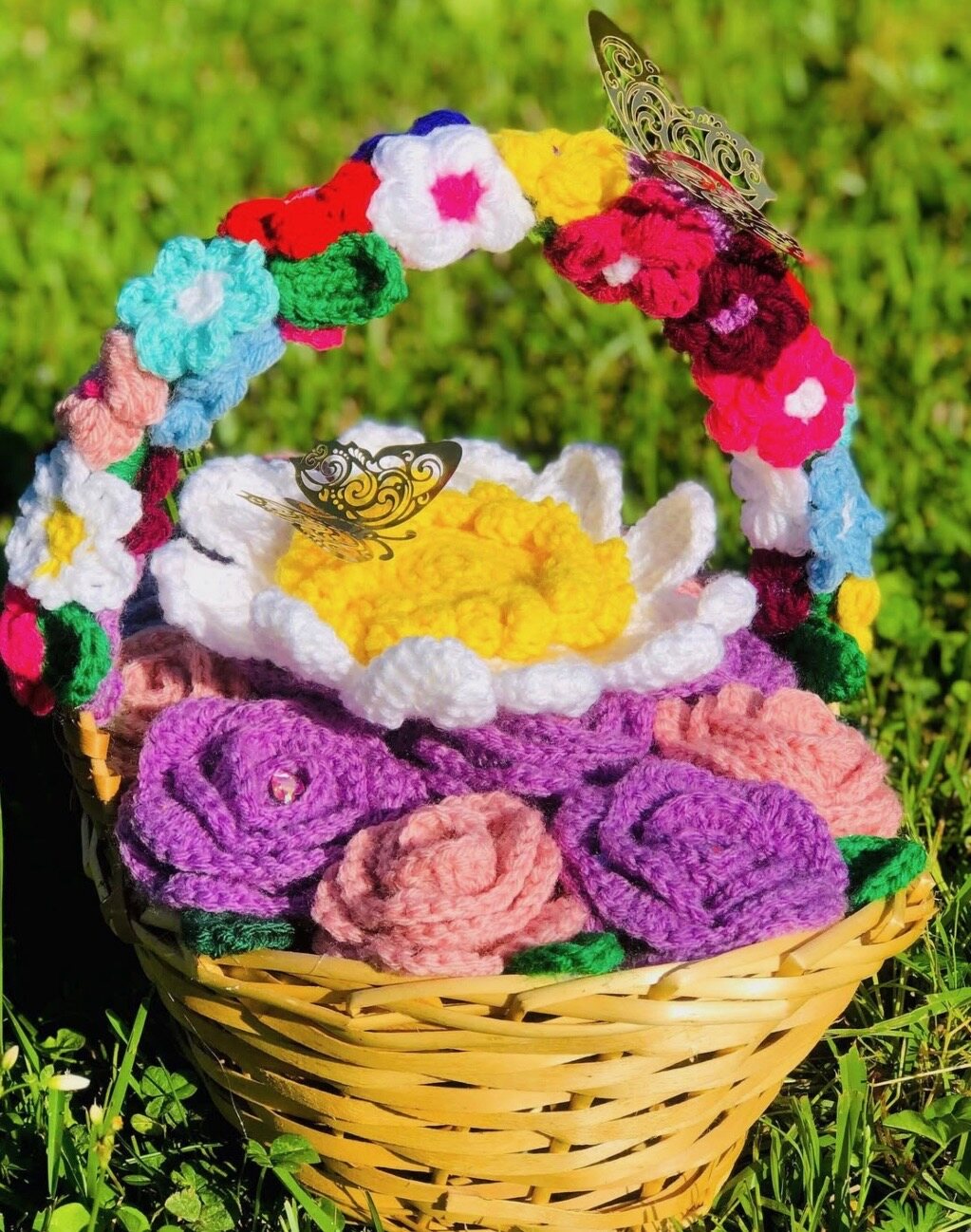Yellow woven basket with crochet roses, daisy and flower-covered handle
