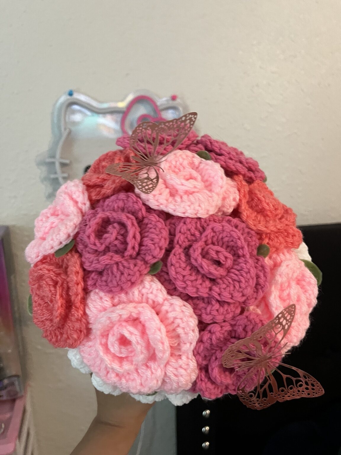 Pink and coral crochet flower bouquet with butterflies