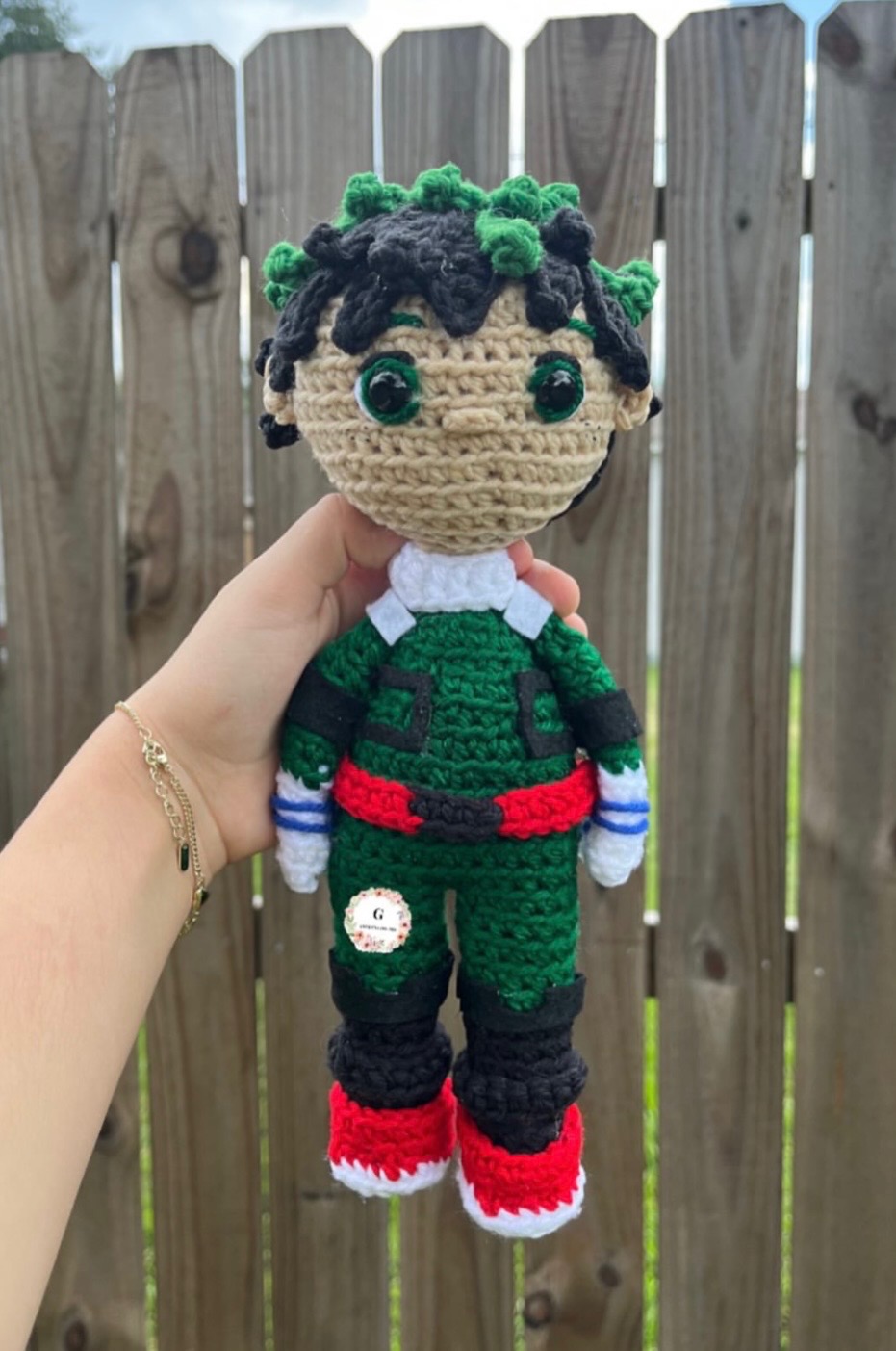 Green hero crochet character plushie in a green uniform