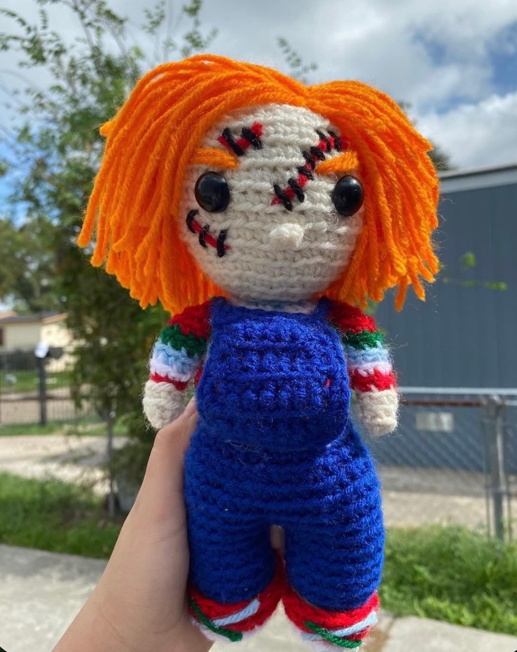 Orange-haired scarred crochet character plushie in blue overalls