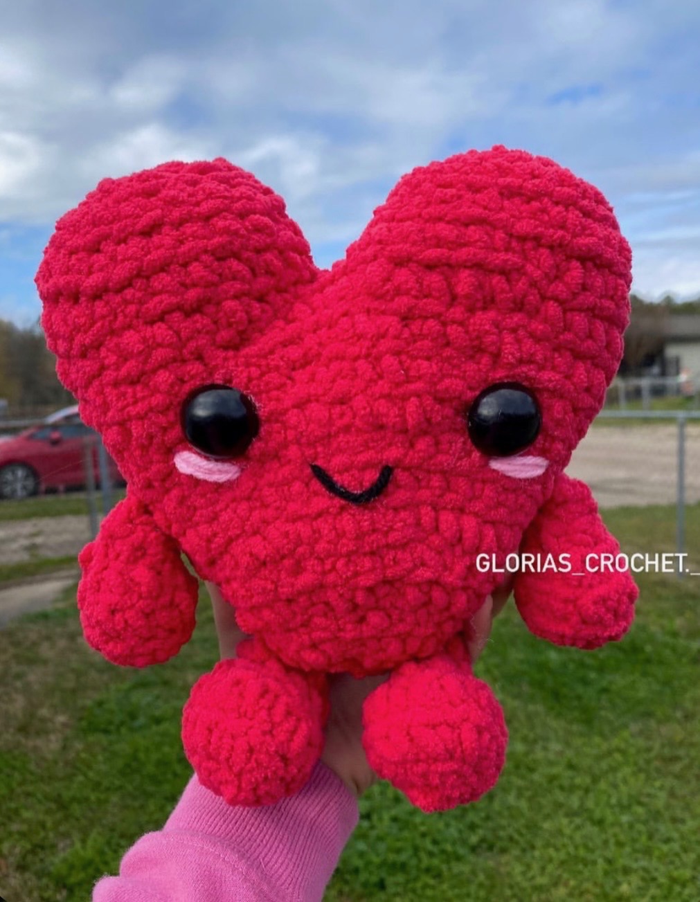 Pink heart-shaped crochet character plushie