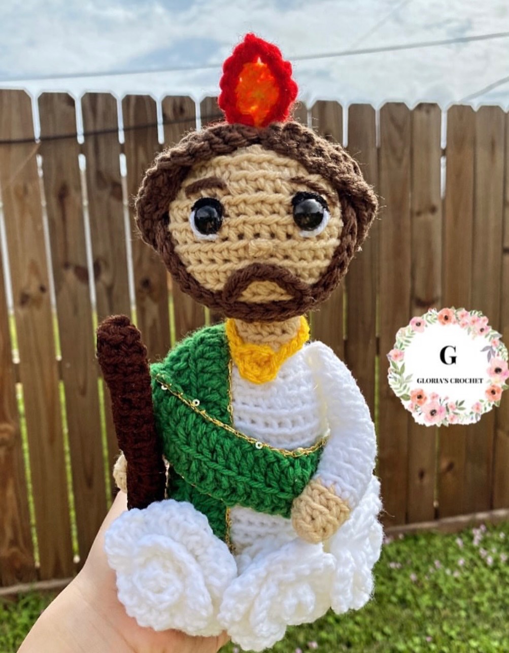Religious flame character crochet plushie with green sash and staff