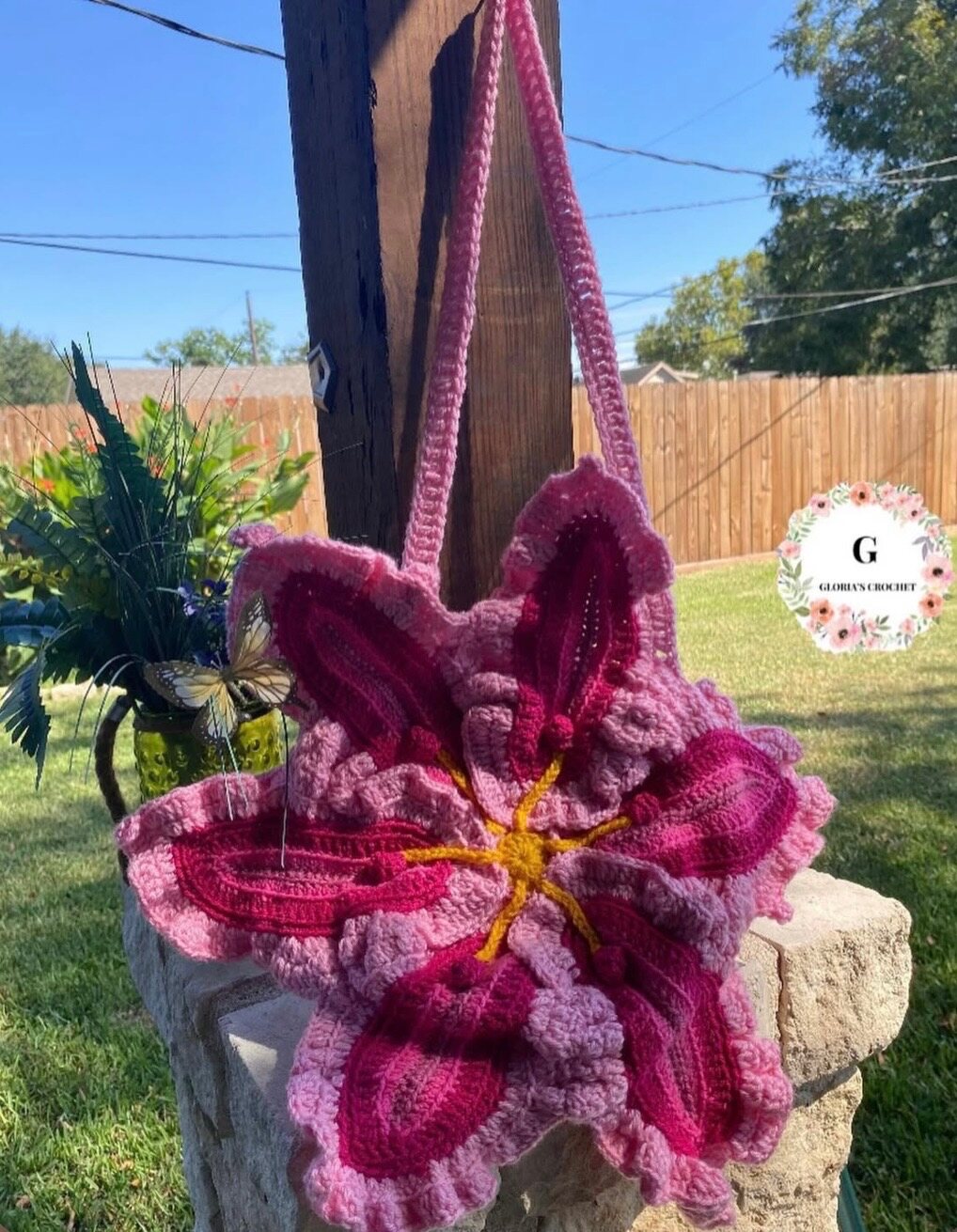Pink crochet shoulder bag shaped like layered flowers