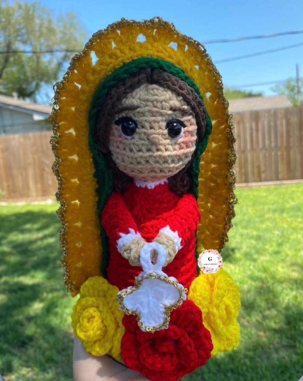Handmade crochet doll in red with a gold halo